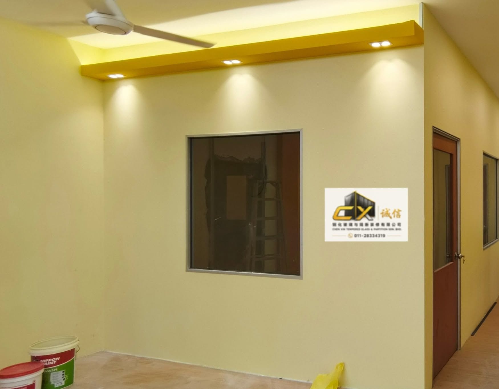 A gypsum-board office fit-out with a plaster cove ceiling, recessed downlights and a framed internal window.